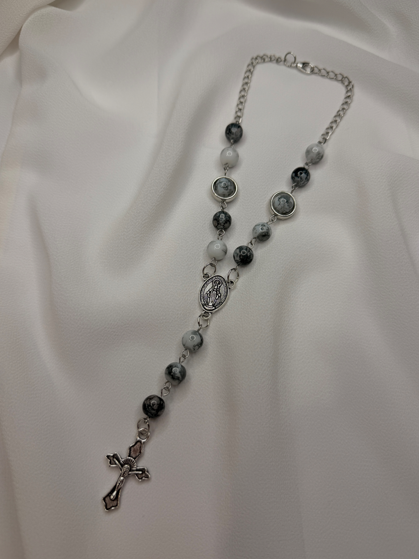 Marbles of Mercy car rosary with black, grey and white marbled stone beads, silver bezel accents, silver Miraculous Medal centerpiece and ornate silver crucifix