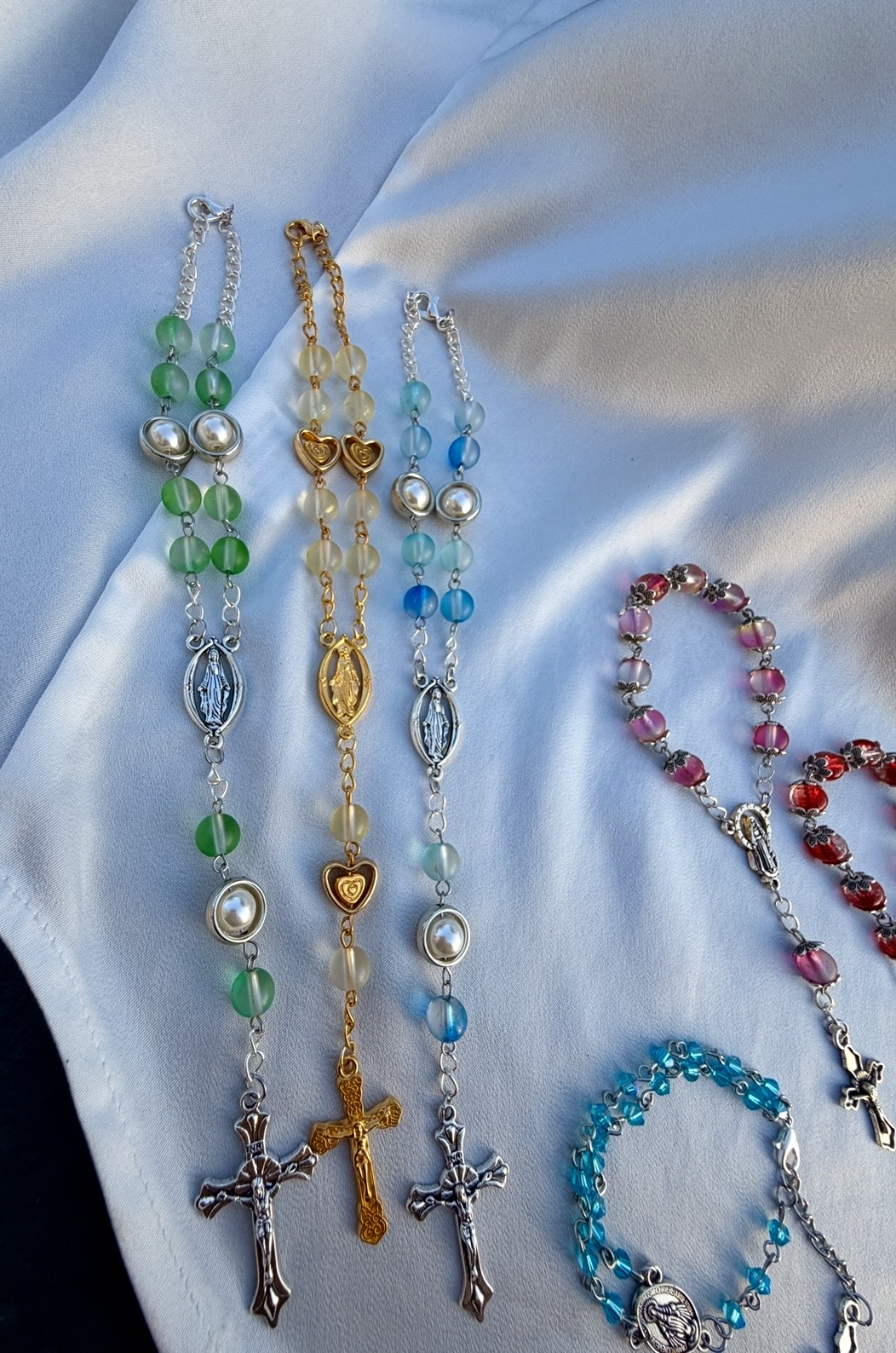Green, cream and blue pocket rosaries with pearl beads and Miraculous Medal centerpieces